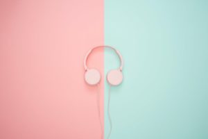 pink corded headphones on pink and teal wall